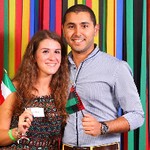 Man and woman smiling holding an Italy and Libya flag